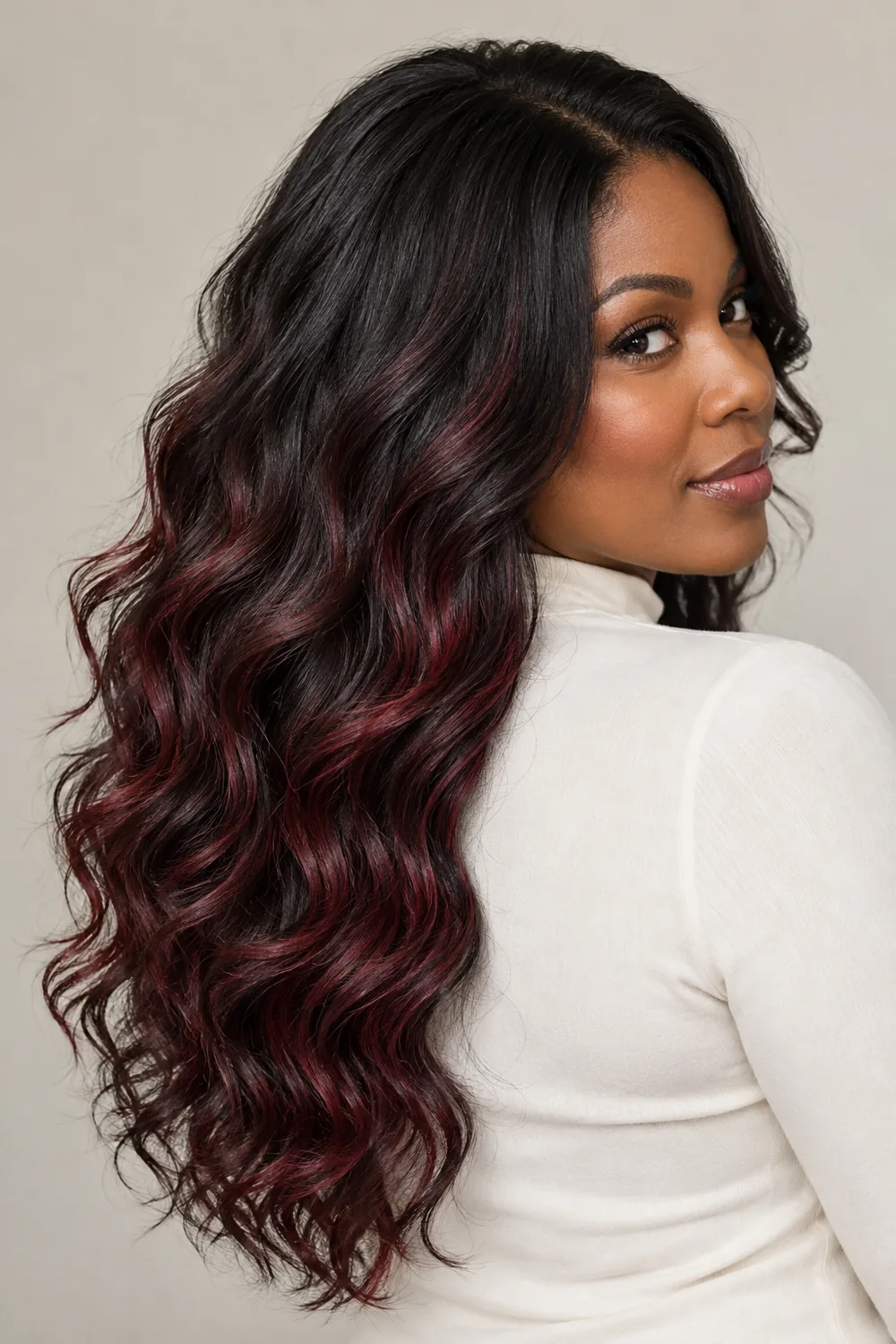 Long black waves with wine-red burgundy ribbons through the lengths, shown in a rear three-quarter portrait.