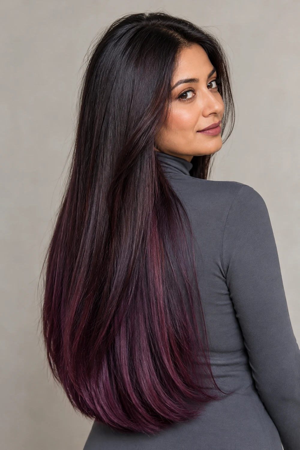 A woman with medium skin and long straight near-black aubergine hair, with violet-plum tones visible through the lower lengths and ends.