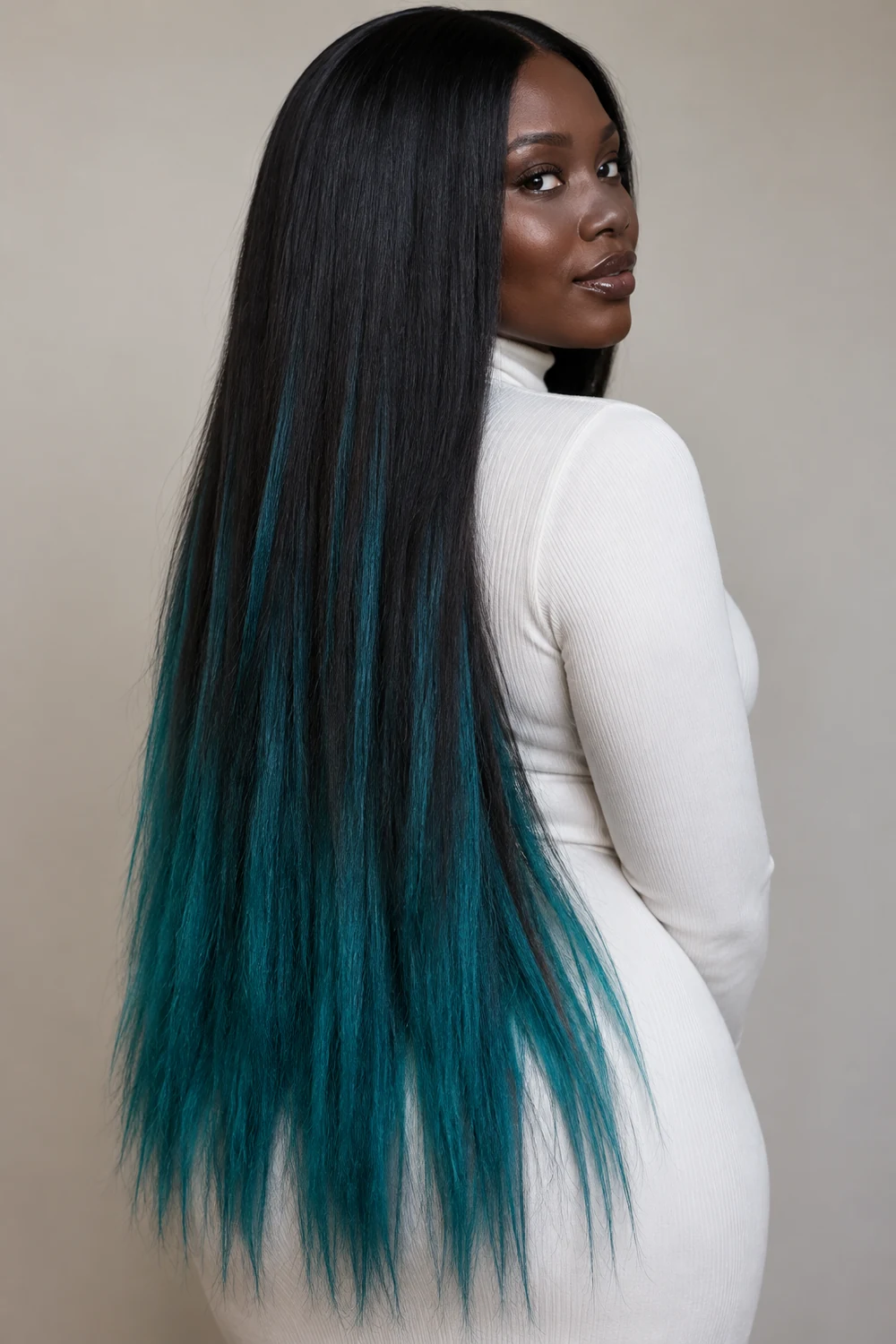 A woman with very deep skin looks over her shoulder, showing extra-long straight nearly black hair with fine teal streaks that deepen into saturated teal ends.